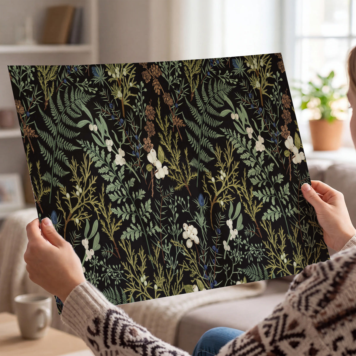 Fine green ferns and cream flowers on a black background single poster print held in hands