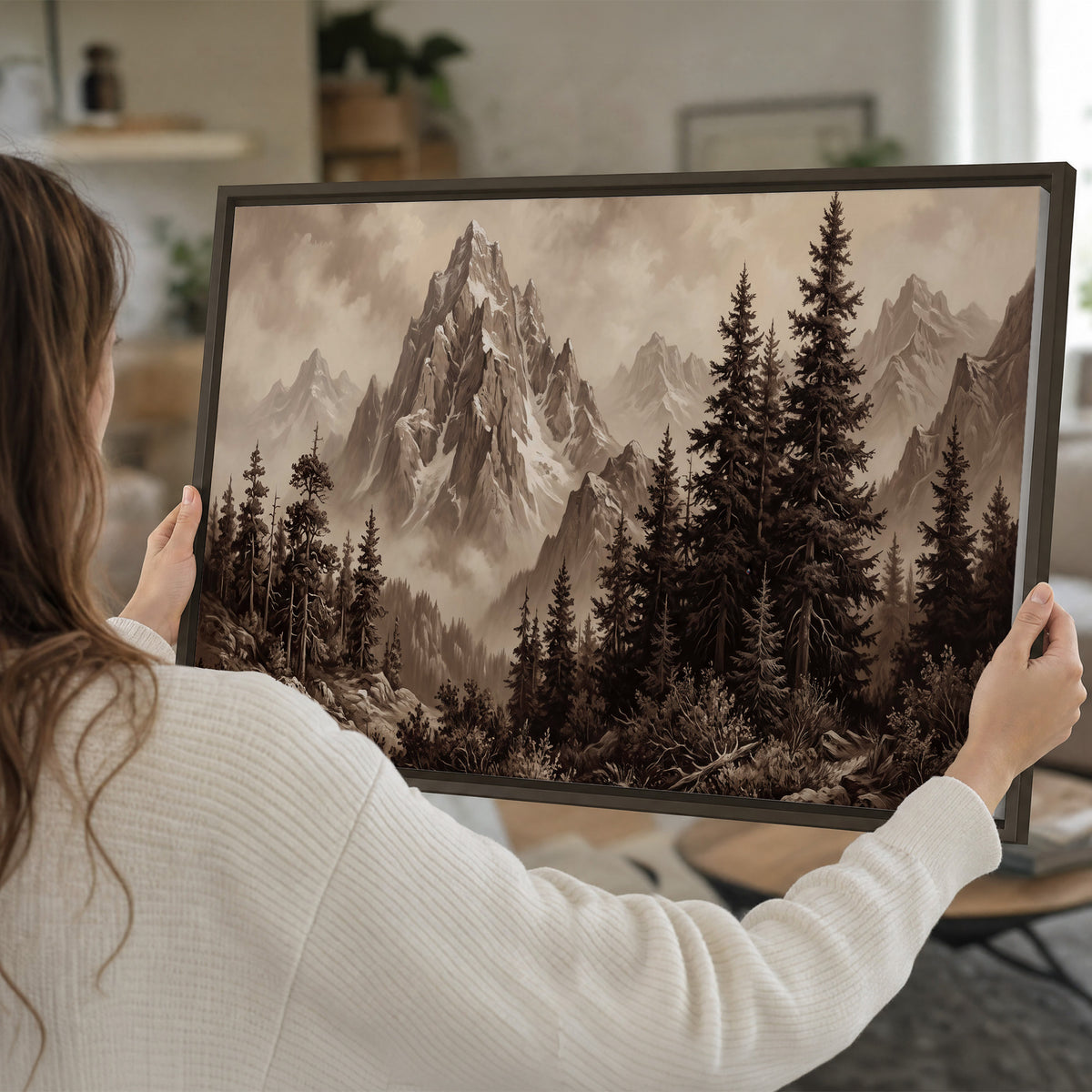 Dramatic mountain peaks framed by evergreen trees single framed canvas wall art held in hands