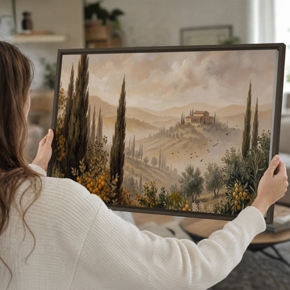 Cypress trees, distant villas and warm rolling hills single framed canvas wall art held in hands