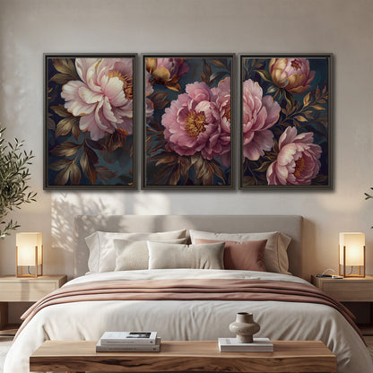Large pink and cream peonies against deep blue foliage 3 piece framed canvas wall art displayed in a bedroom