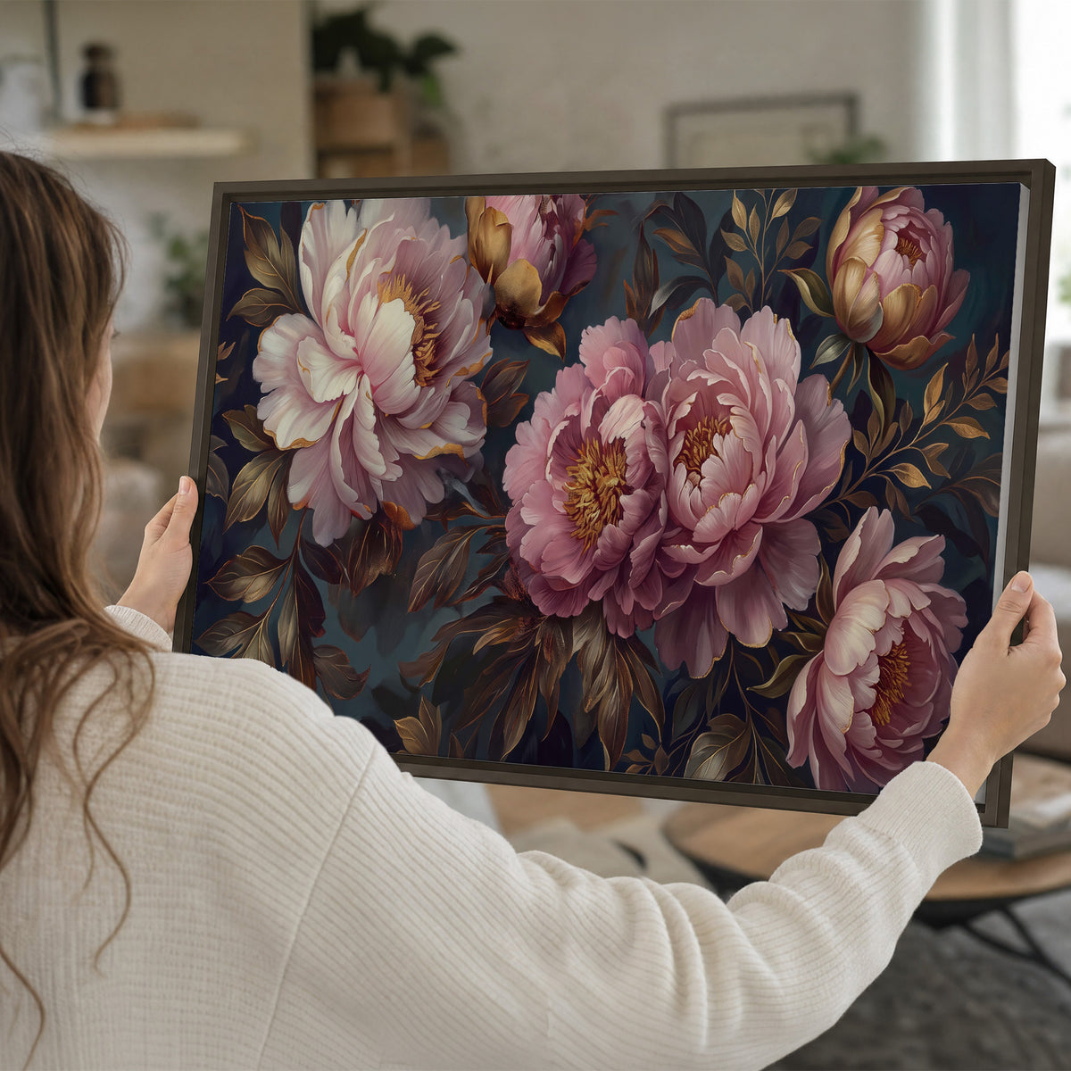 Large pink and cream peonies against deep blue foliage single framed canvas wall art held in hands