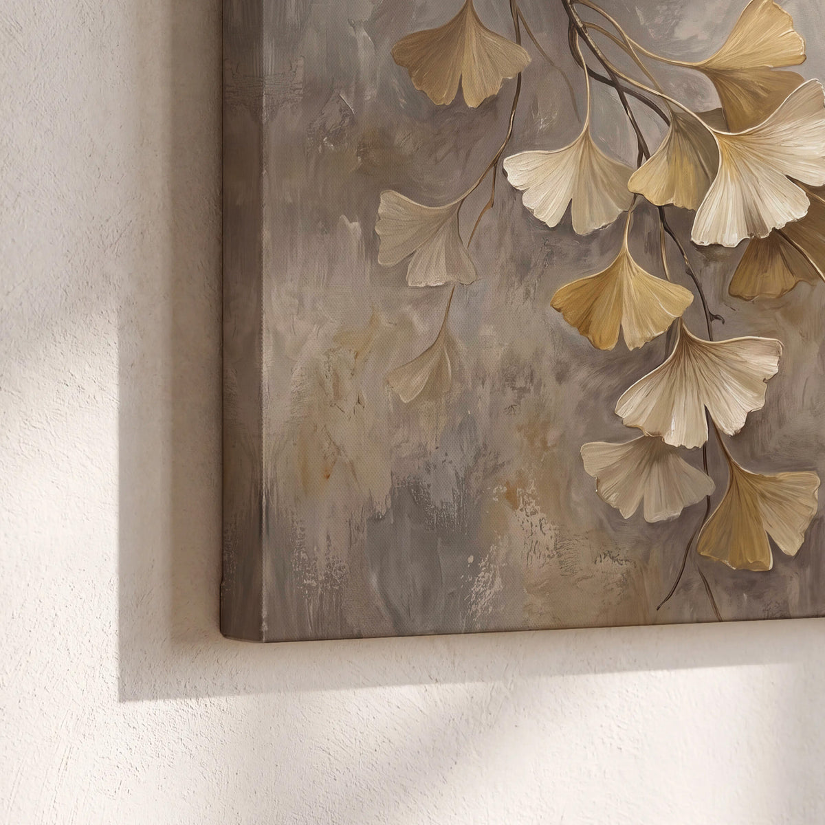 Cream and gold-colored ginkgo leaves against warm gray 3 piece canvas wall art material and edge close up