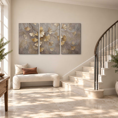 Cream and gold-colored ginkgo leaves against warm gray 3 piece canvas wall art styled in an interior