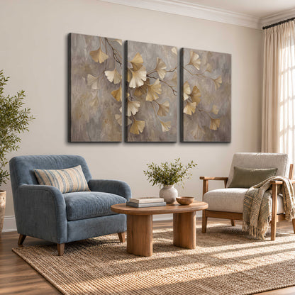 Cream and gold-colored ginkgo leaves against warm gray 3 piece canvas wall art styled in an interior
