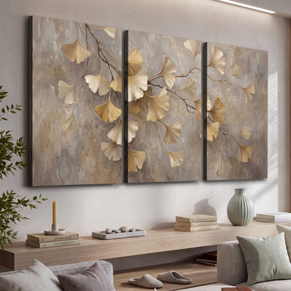 Cream and gold-colored ginkgo leaves against warm gray 3 piece canvas wall art displayed in a console