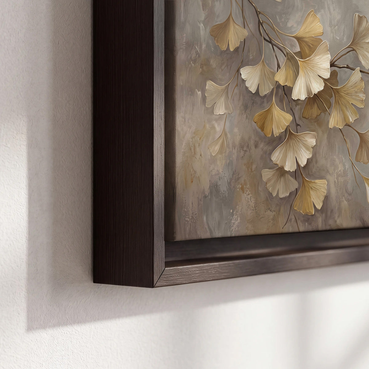 Cream and gold-colored ginkgo leaves against warm gray 3 piece framed canvas wall art material and edge close up