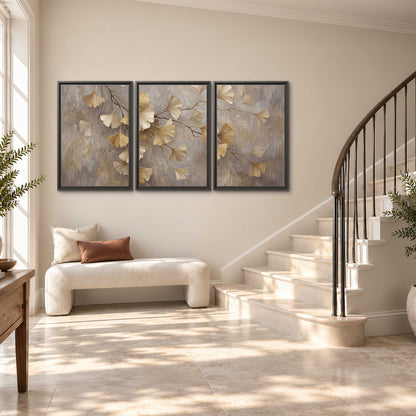 Cream and gold-colored ginkgo leaves against warm gray 3 piece framed canvas wall art styled in an interior