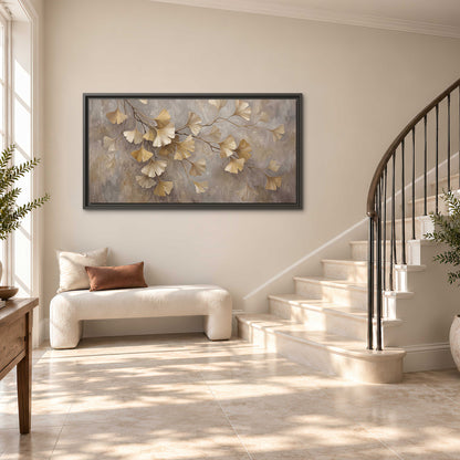 Cream and gold-colored ginkgo leaves against warm gray single framed canvas wall art styled in an interior