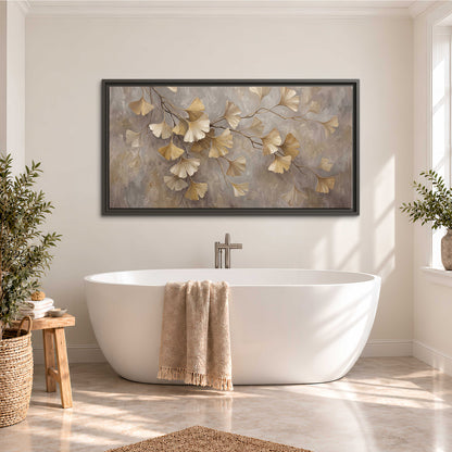 Cream and gold-colored ginkgo leaves against warm gray single framed canvas wall art styled in an interior