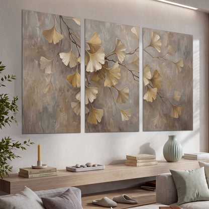 Cream and gold-colored ginkgo leaves against warm gray set of 3 poster prints displayed in a console
