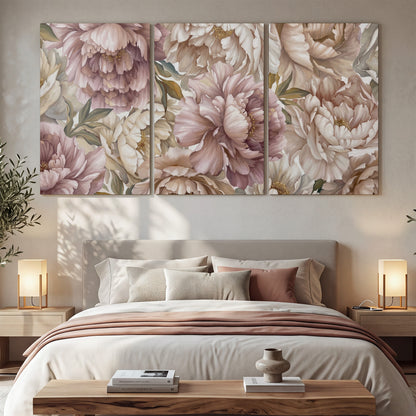 Layered soft pink and ivory flowers with sage leaves 3 piece canvas wall art displayed in a bedroom