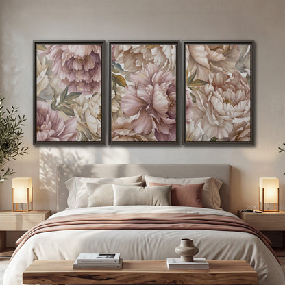 Layered soft pink and ivory flowers with sage leaves 3 piece framed canvas wall art displayed in a bedroom