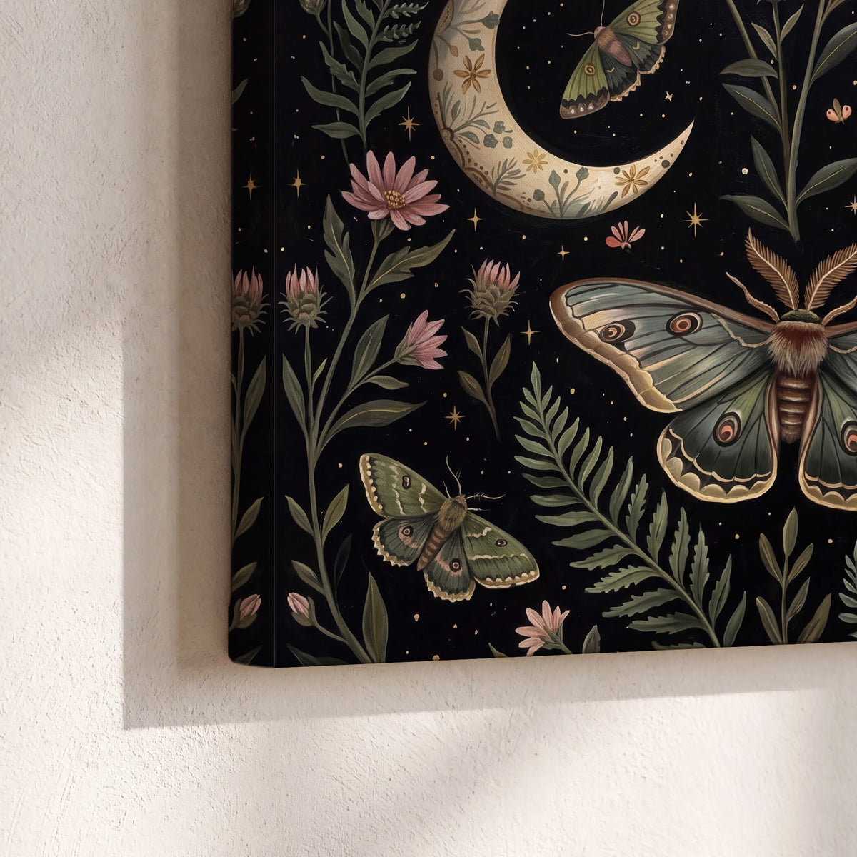Decorative moths, crescent moons and flowers on black 3 piece canvas wall art material and edge close up