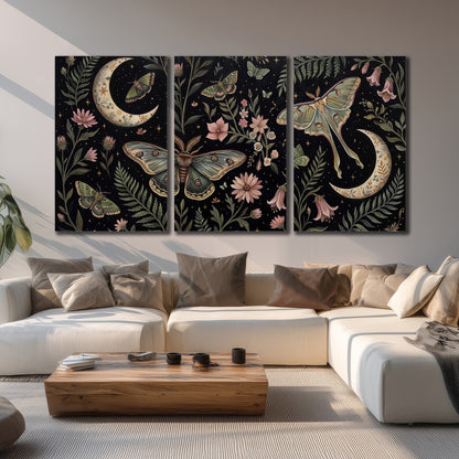 Decorative moths, crescent moons and flowers on black 3 piece canvas wall art displayed in a living room