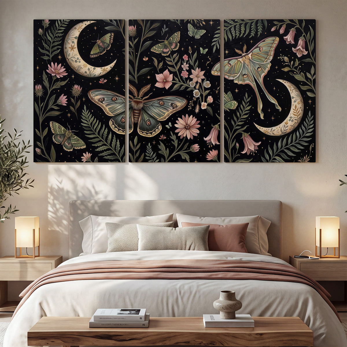 Decorative moths, crescent moons and flowers on black 3 piece canvas wall art displayed in a bedroom
