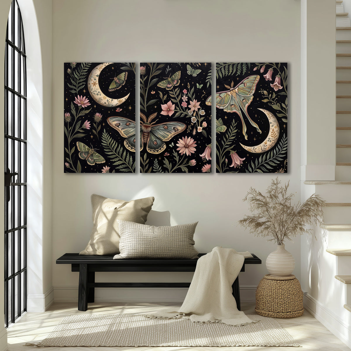 Decorative moths, crescent moons and flowers on black 3 piece canvas wall art displayed in a entryway