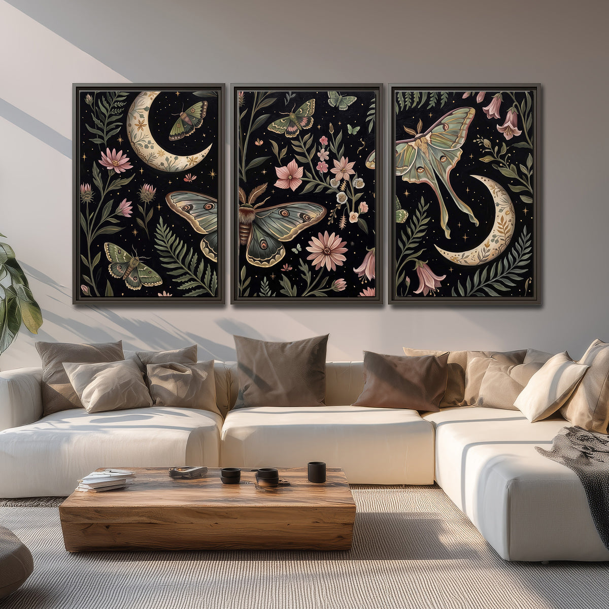 Decorative moths, crescent moons and flowers on black 3 piece framed canvas wall art displayed in a living room