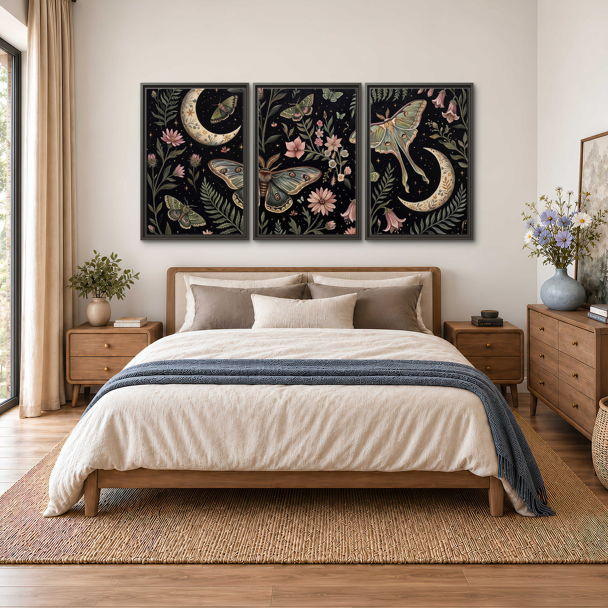 Decorative moths, crescent moons and flowers on black 3 piece framed canvas wall art styled in an interior