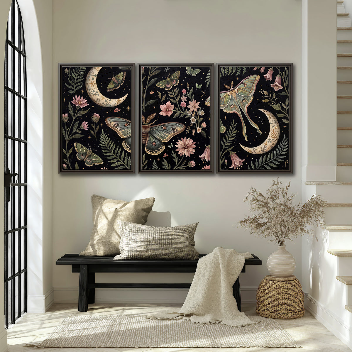 Decorative moths, crescent moons and flowers on black 3 piece framed canvas wall art displayed in a entryway