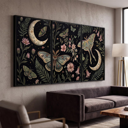 Decorative moths, crescent moons and flowers on black 3 piece framed canvas wall art displayed in a modern living room