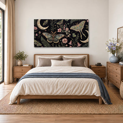 Decorative moths, crescent moons and flowers on black single canvas wall art styled in an interior