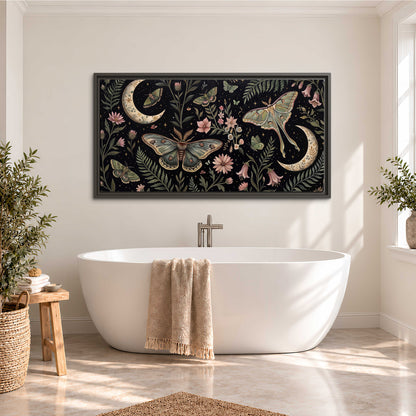 Decorative moths, crescent moons and flowers on black single framed canvas wall art styled in an interior