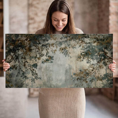 Overhanging branches framing a misty woodland clearing single canvas wall art held in hands