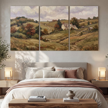 Warm rolling fields and countryside cottages beneath soft clouds 3 piece canvas wall art displayed in a bedroom