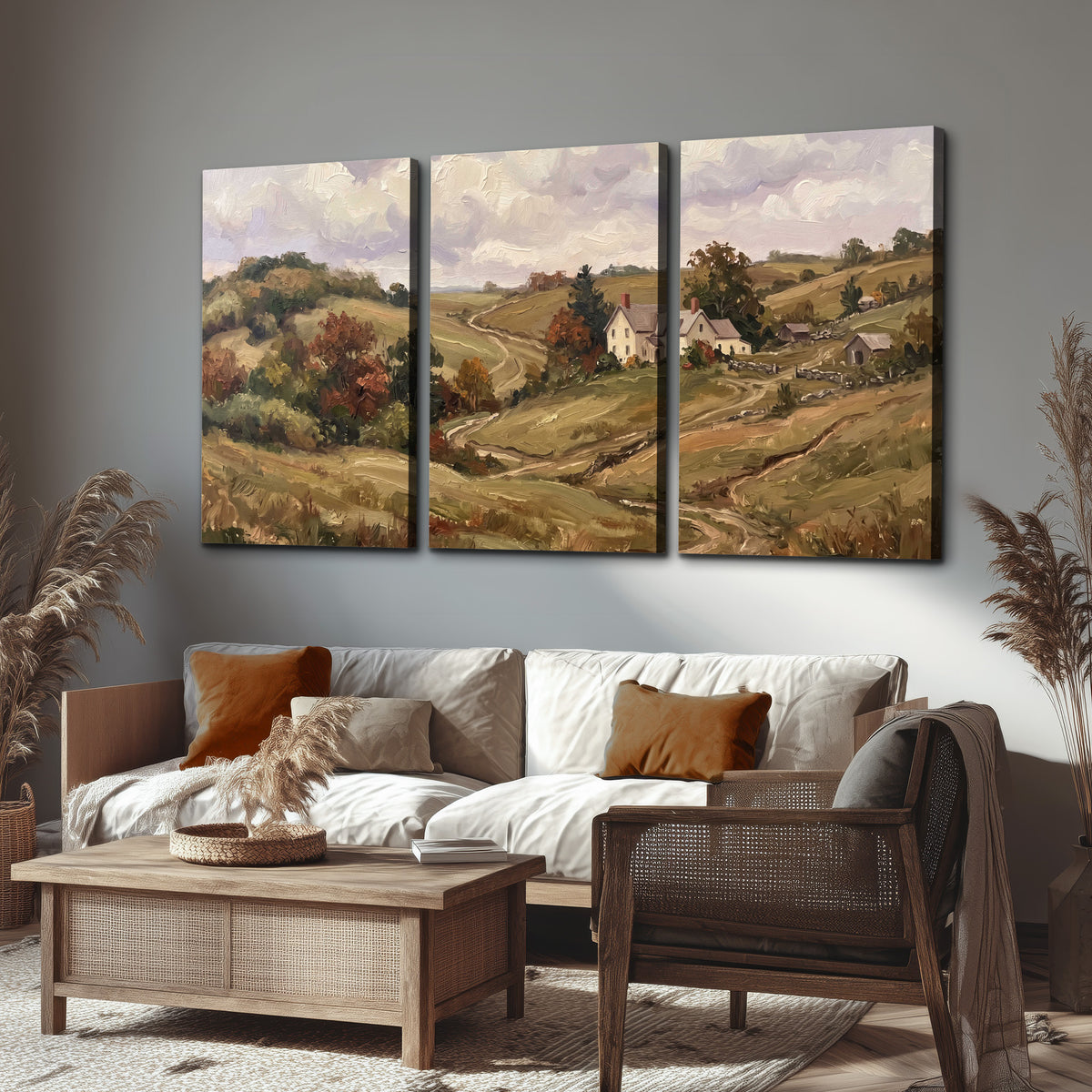 Warm rolling fields and countryside cottages beneath soft clouds 3 piece canvas wall art displayed in a rustic living room