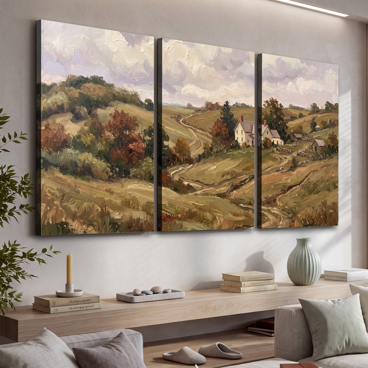 Warm rolling fields and countryside cottages beneath soft clouds 3 piece canvas wall art displayed in a console