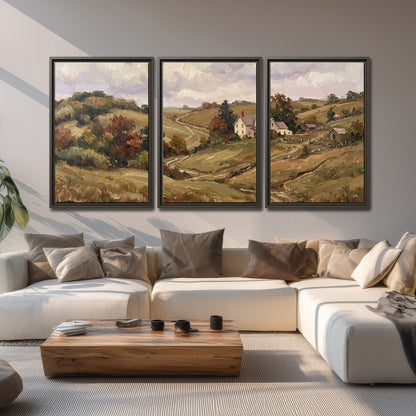 Warm rolling fields and countryside cottages beneath soft clouds 3 piece framed canvas wall art displayed in a living room