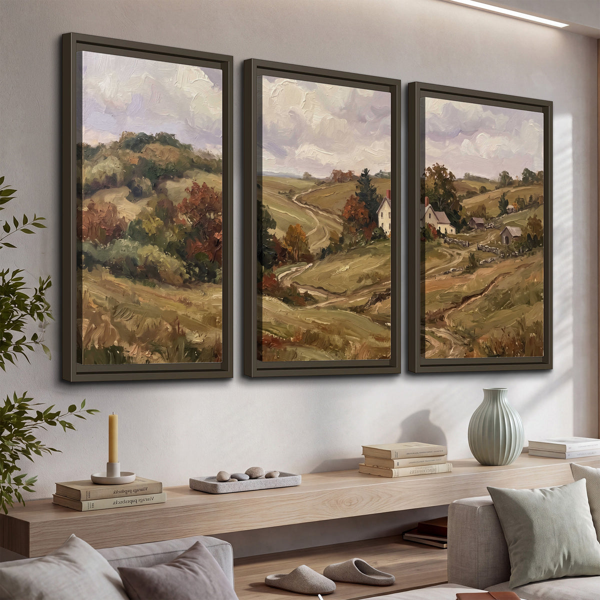 Warm rolling fields and countryside cottages beneath soft clouds 3 piece framed canvas wall art displayed in a console
