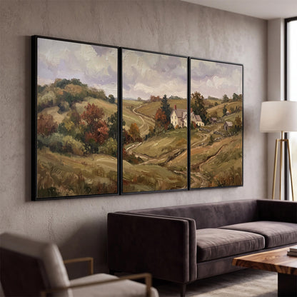 Warm rolling fields and countryside cottages beneath soft clouds 3 piece framed canvas wall art displayed in a modern living room