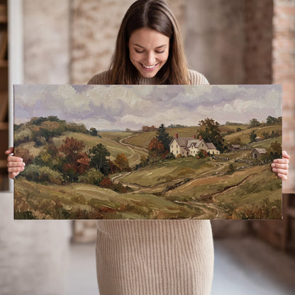 Warm rolling fields and countryside cottages beneath soft clouds single canvas wall art held in hands