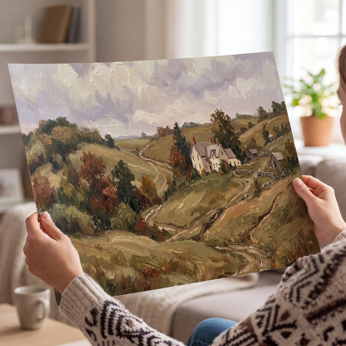 Warm rolling fields and countryside cottages beneath soft clouds single poster print held in hands