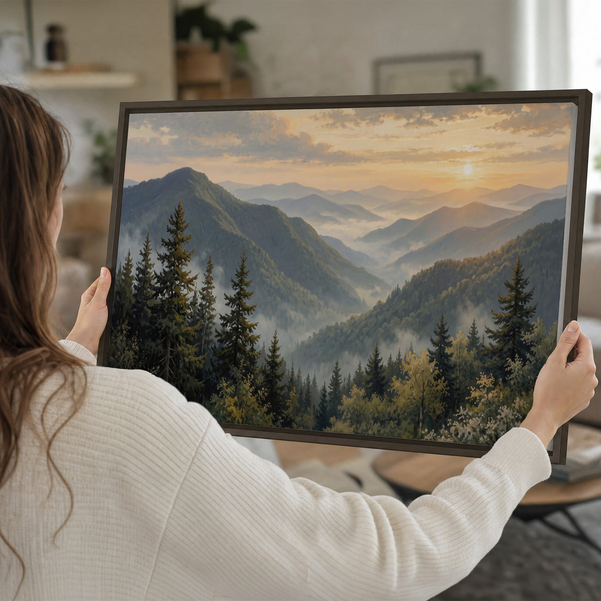 Blue-green mountain ridges and pines beneath a golden sunset single framed canvas wall art held in hands