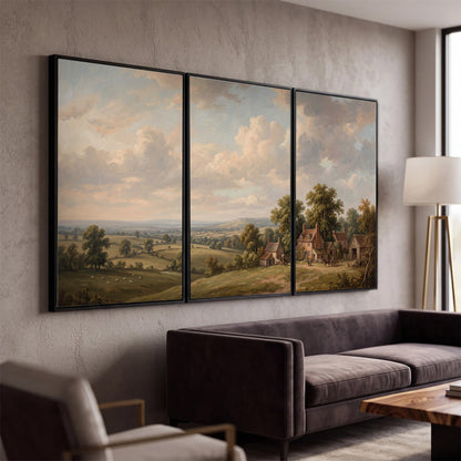 Small cottages overlooking fields beneath a luminous cloudy sky 3 piece framed canvas wall art displayed in a modern living room