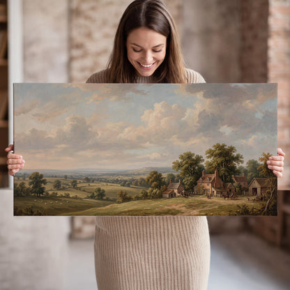 Small cottages overlooking fields beneath a luminous cloudy sky single canvas wall art held in hands