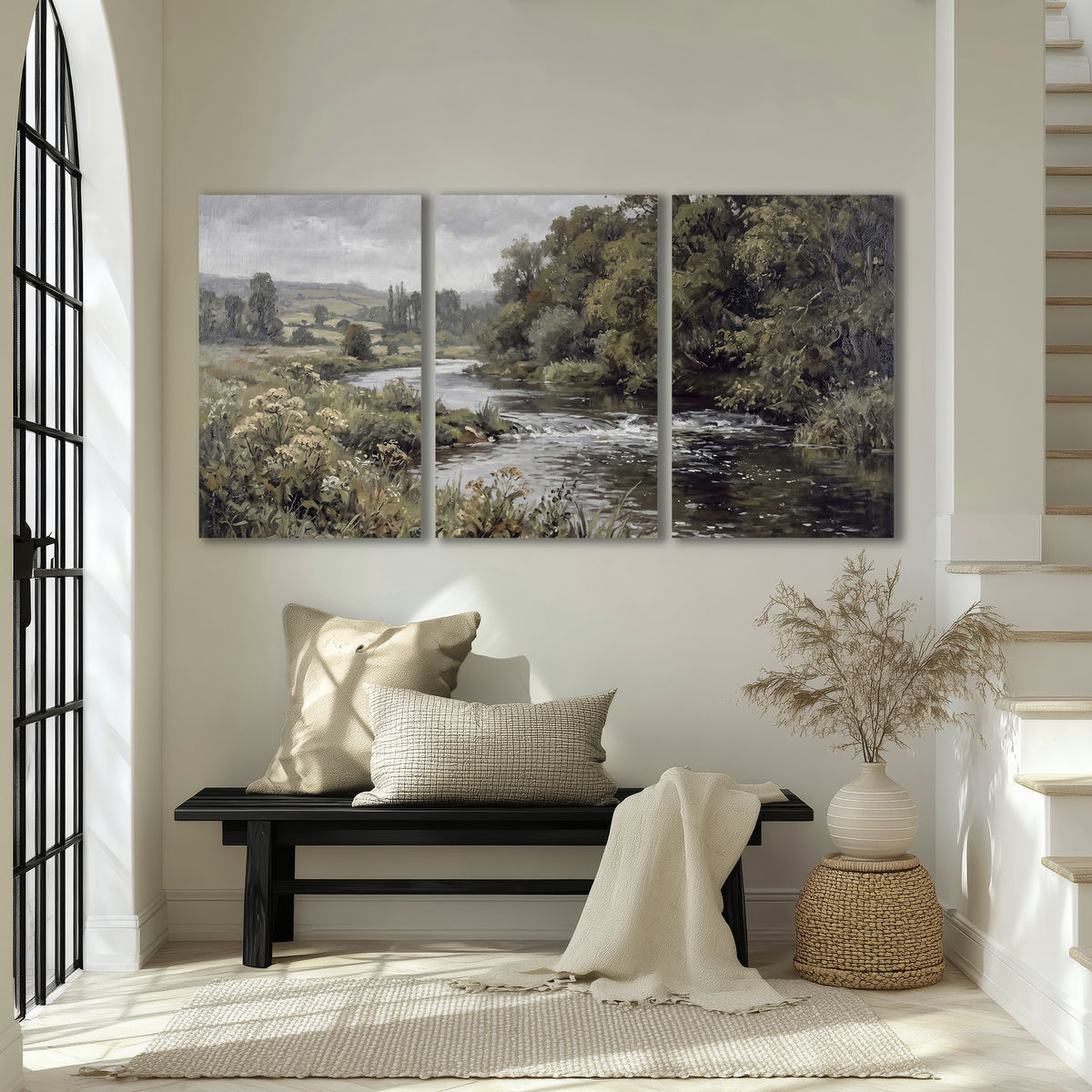 A gently flowing river bordered by olive-green trees and flowers 3 piece canvas wall art displayed in a entryway