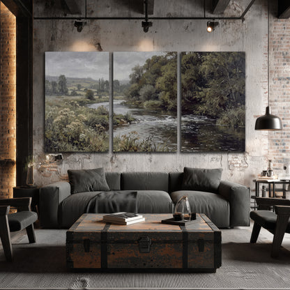 A gently flowing river bordered by olive-green trees and flowers 3 piece canvas wall art displayed in a industrial room