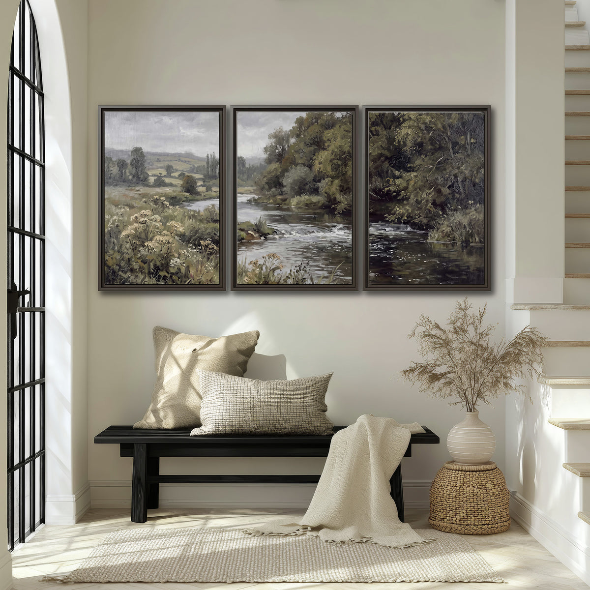 A gently flowing river bordered by olive-green trees and flowers 3 piece framed canvas wall art displayed in a entryway