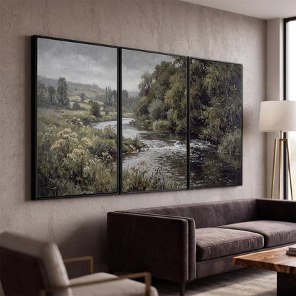 A gently flowing river bordered by olive-green trees and flowers 3 piece framed canvas wall art displayed in a modern living room