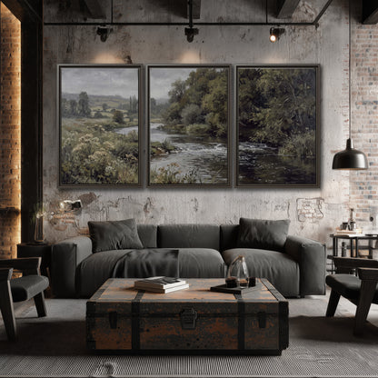 A gently flowing river bordered by olive-green trees and flowers 3 piece framed canvas wall art displayed in a industrial room