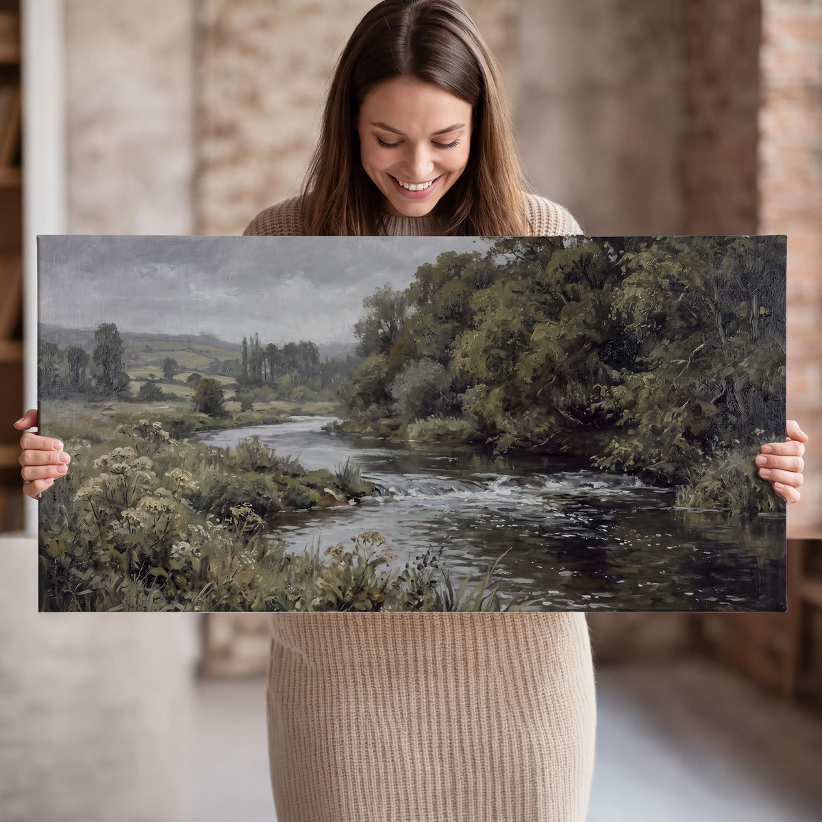 A gently flowing river bordered by olive-green trees and flowers single canvas wall art held in hands