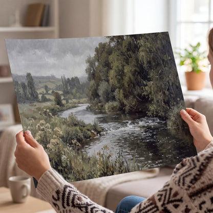A gently flowing river bordered by olive-green trees and flowers single poster print held in hands