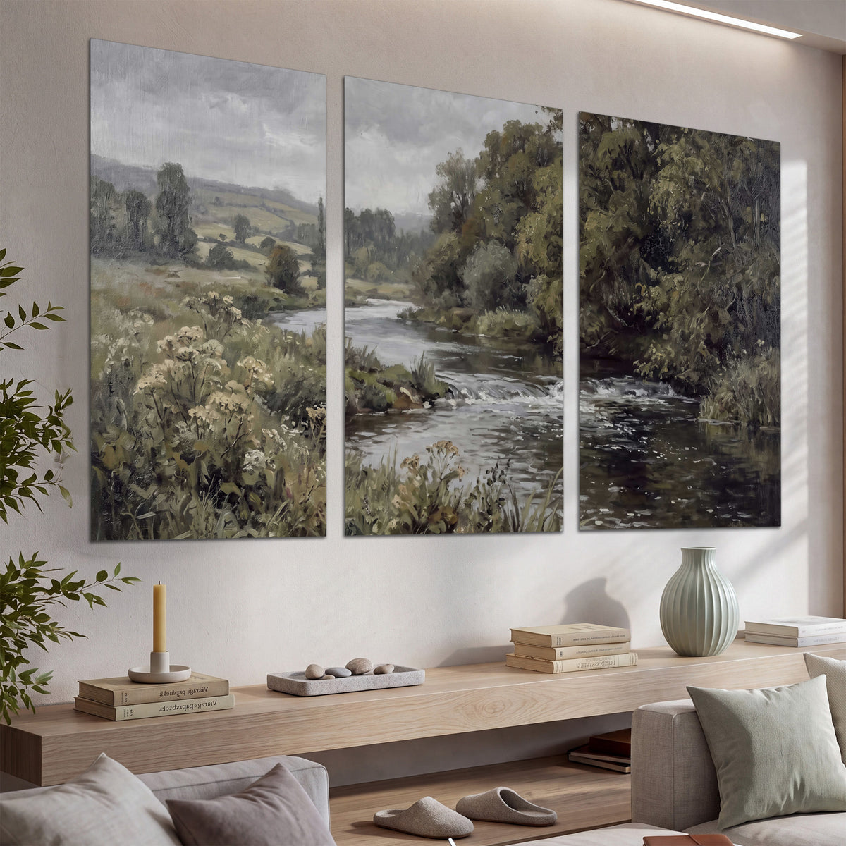 A gently flowing river bordered by olive-green trees and flowers set of 3 poster prints displayed in a console