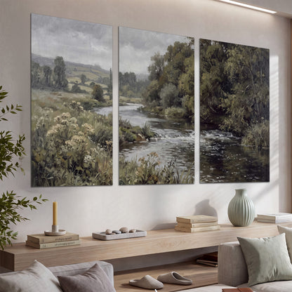 A gently flowing river bordered by olive-green trees and flowers set of 3 poster prints displayed in a console