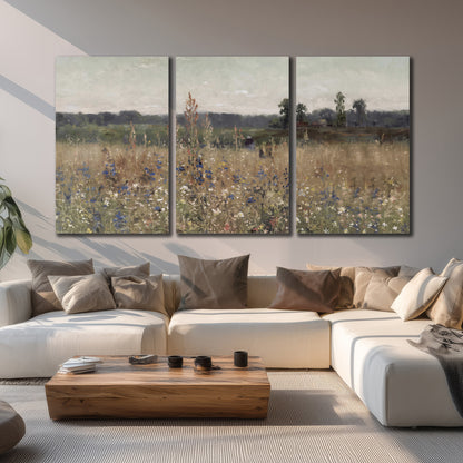 A loose painterly meadow with scattered blue and white wildflowers 3 piece canvas wall art displayed in a living room