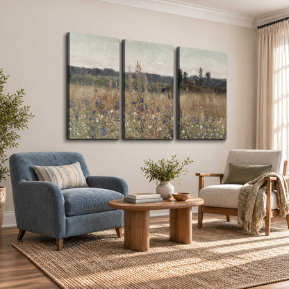 A loose painterly meadow with scattered blue and white wildflowers 3 piece canvas wall art styled in an interior