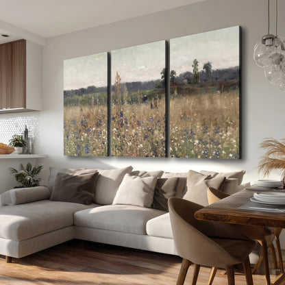 A loose painterly meadow with scattered blue and white wildflowers 3 piece canvas wall art room and product view